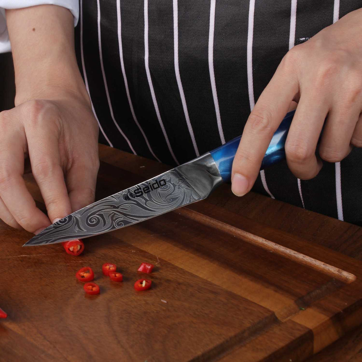 Tengoku 10-piece kitchen knife set detail of Damascus-pattern blade and blue handle