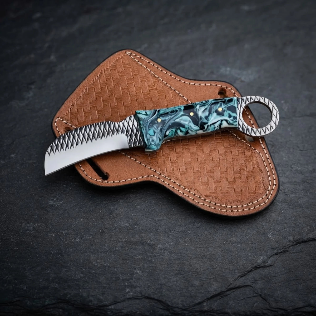 Handmade hawkbill knife with teal marble resin handle and toothed ring pommel