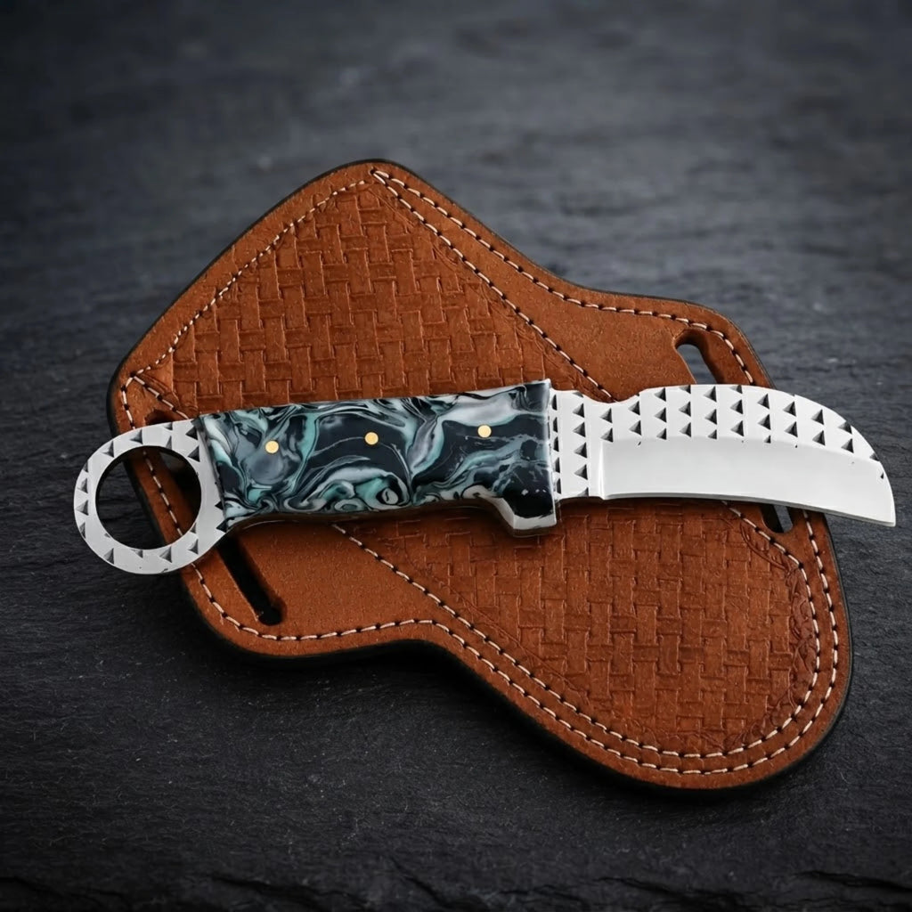 Handmade hawkbill knife with teal marble resin handle and toothed ring pommel – teal black and white marble resin handle close-up