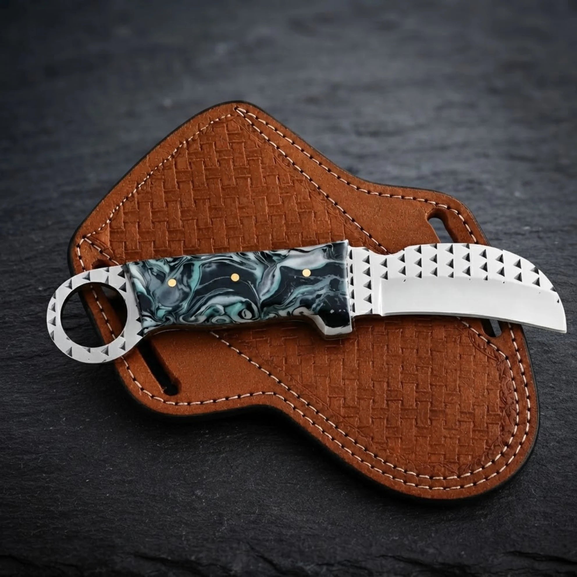 Handmade hawkbill knife with teal marble resin handle and toothed ring pommel – teal black and white marble resin handle close-up