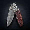 Walnut wood folding knife with engraved brass bolster and Damascus blade – full view