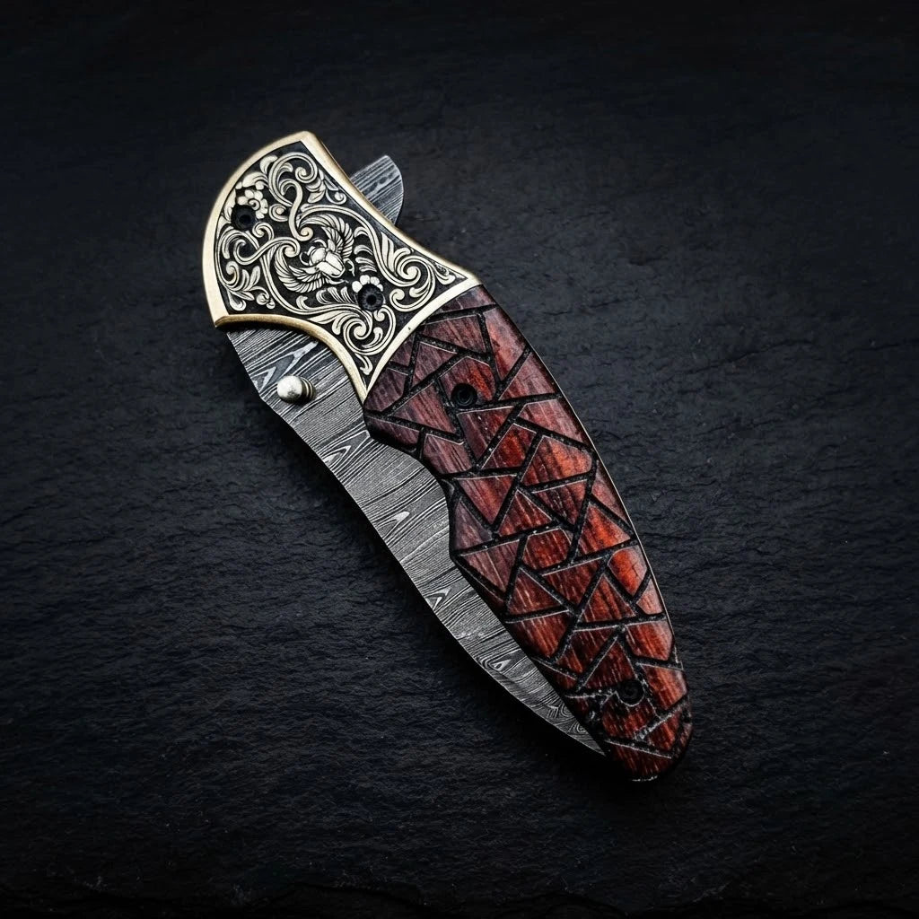 Walnut wood folding knife with engraved brass bolster and Damascus blade – blade close-up