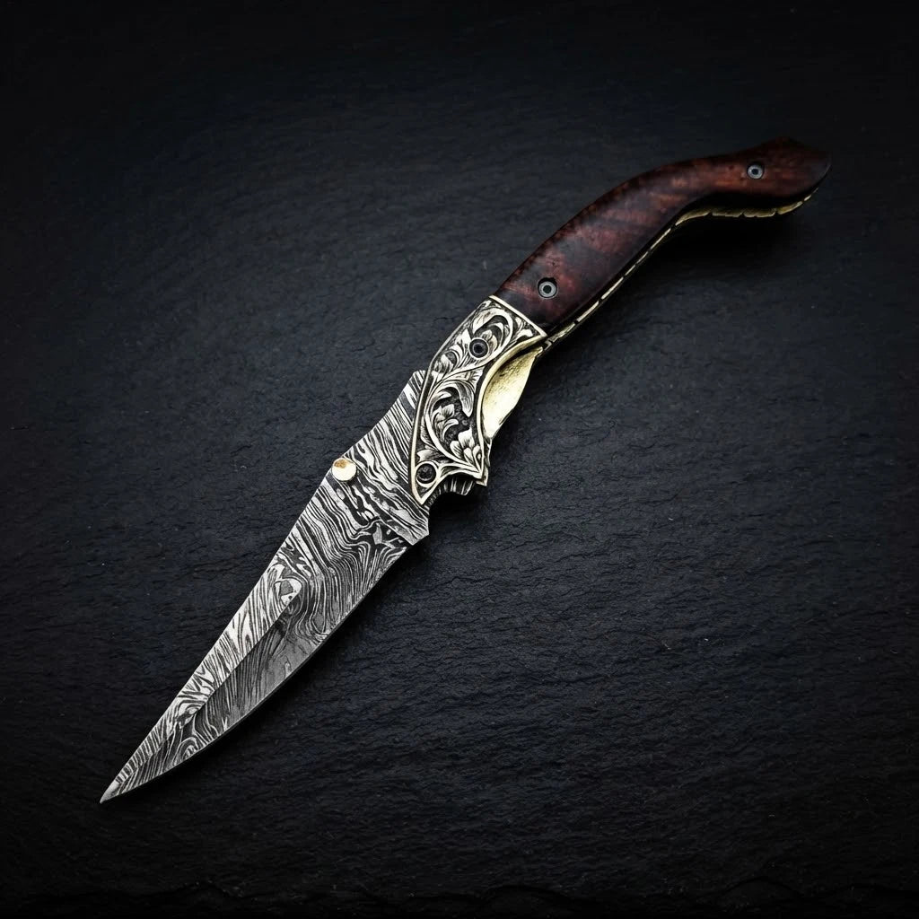 Damascus folding knife with walnut wood handle and engraved brass bolster – folded with sheath