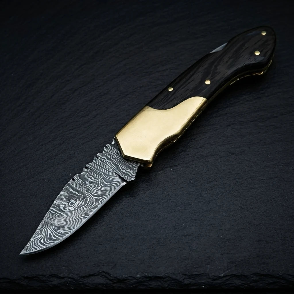 Damascus folding knife — sabre grind blade profile